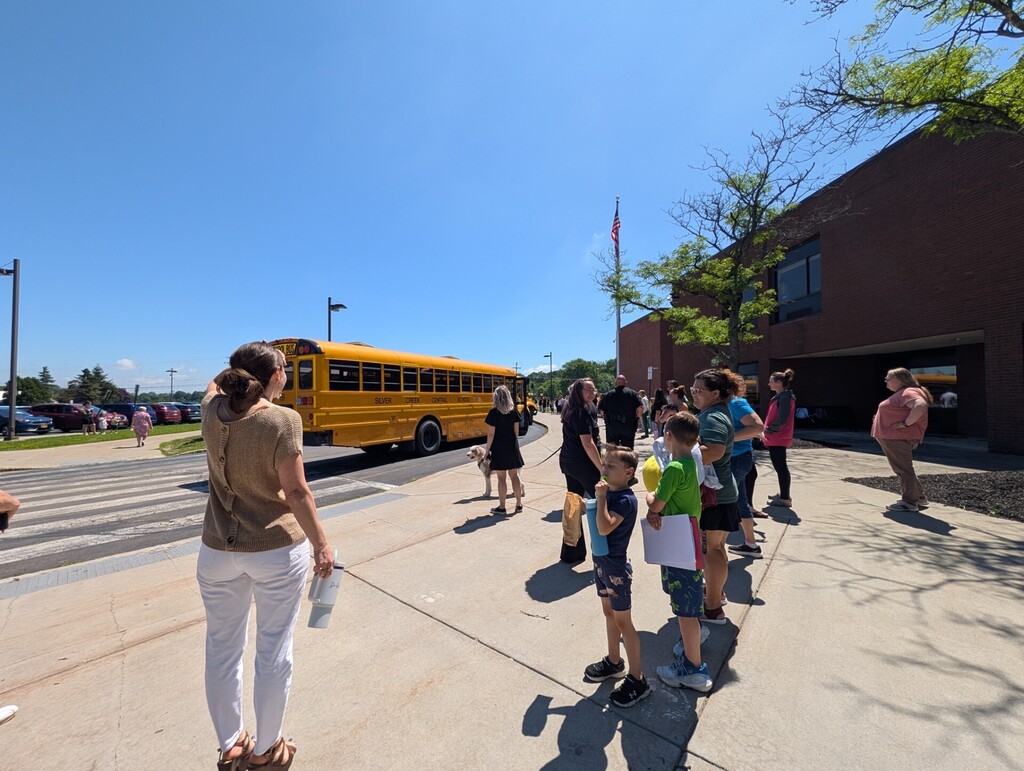 Staff waving to buses