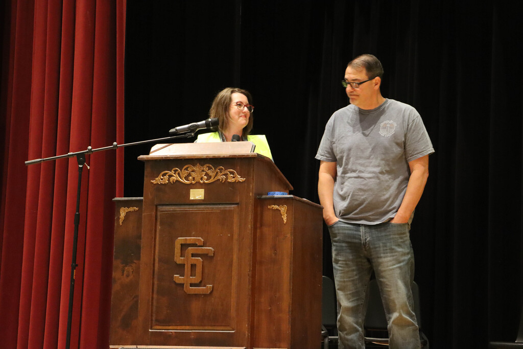 Mrs. Krystofiak and Mr. Rice at the podium. 
