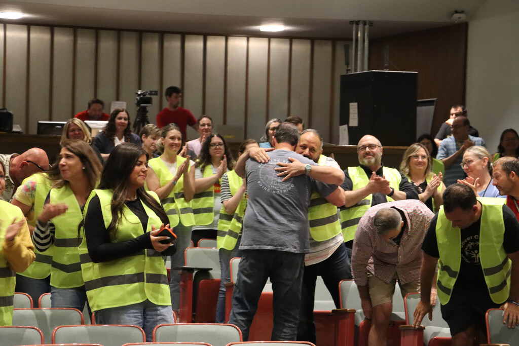 Mr. Baldelli hugs Mr. Rice as the crowd claps. 
