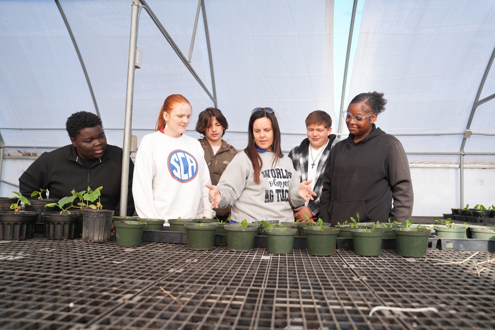 Agriculture and Natural Resources  class  discussing plants in the green house