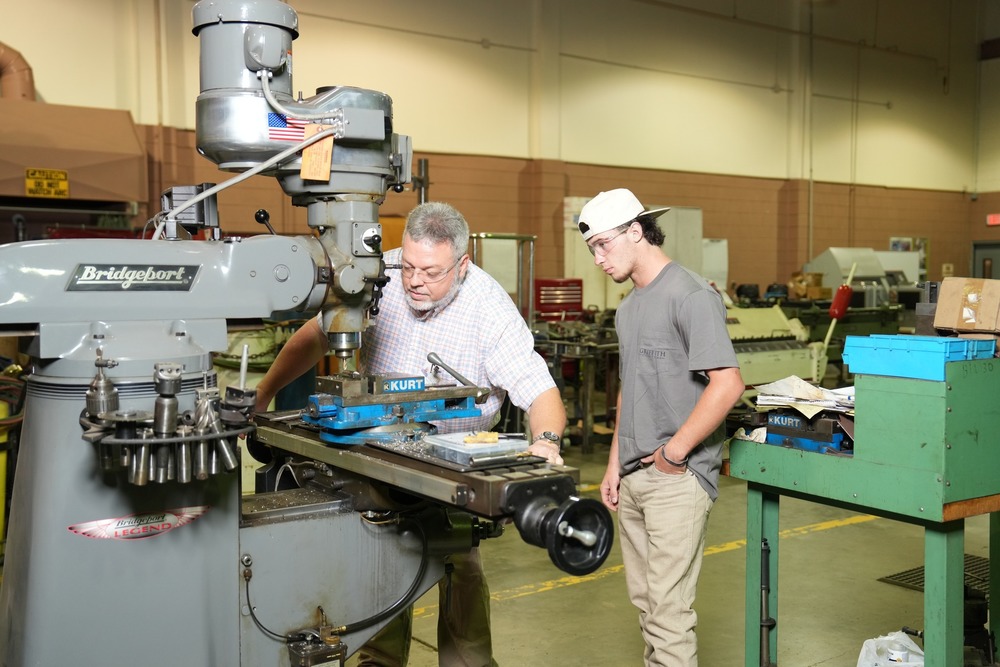 Metal Fabrication instructor demonstrating how to use a machine.