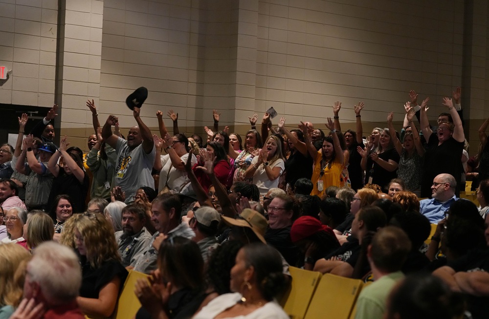 Mendenhall Elementary staff shouting in excitement at convocation.