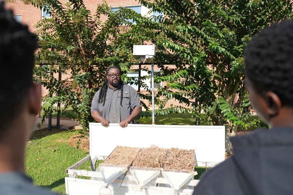 Lee Jones, USDA Soil Scientist, explains the rainfall simulator.