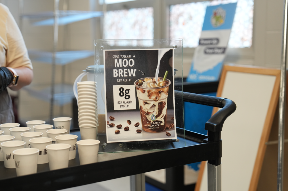 Moo Brew sign on a cart with samples of Moo Brew coffee.