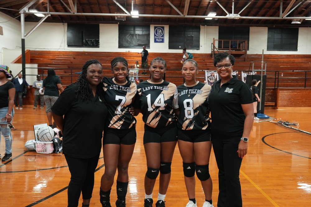 Volleyball Seniors pose with coaches