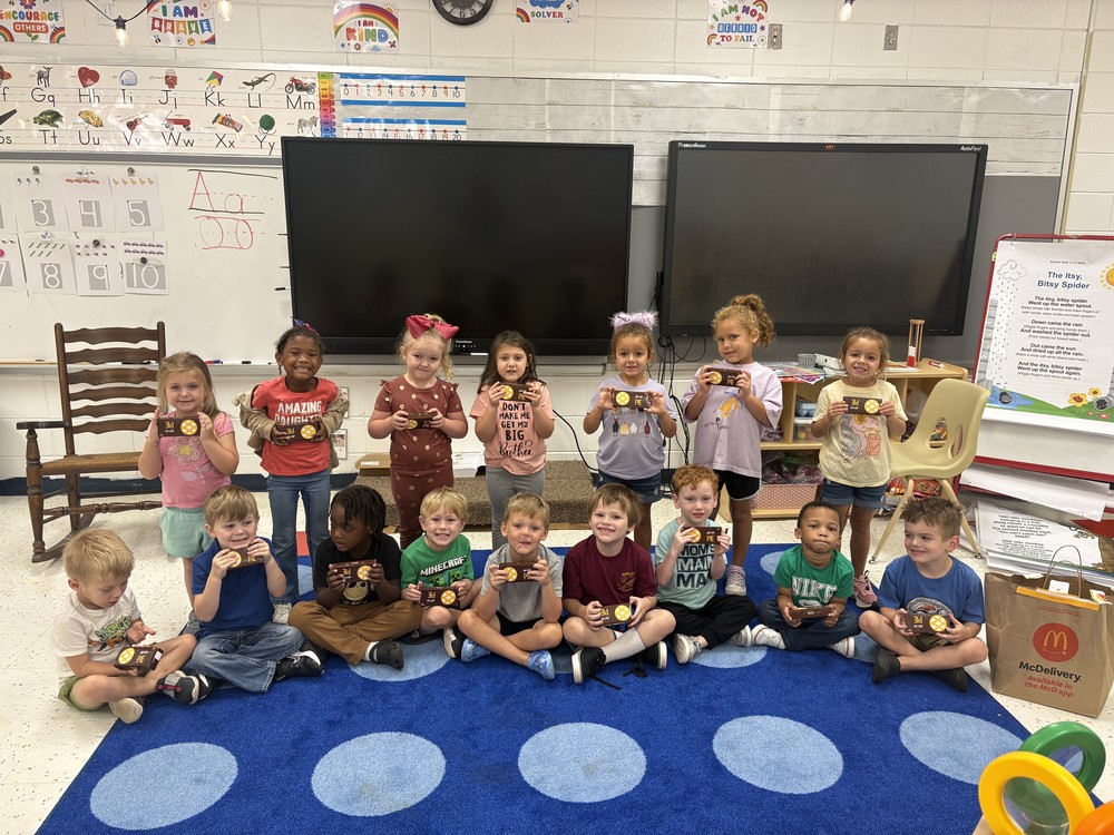 Pre-K students pose with Apple pies