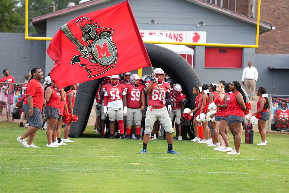 Trojan Football team and cheerleaders preparing to run out of tunnel.