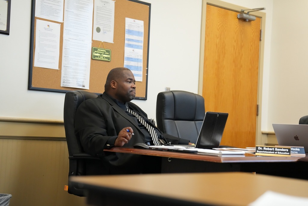 SCSD Superintendent, Dr. Robert Sanders, sitting at the board table at a board meeting. 
