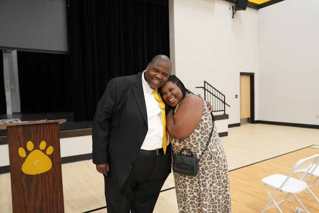 Dr. Robert Sanders and a former student hugging. 