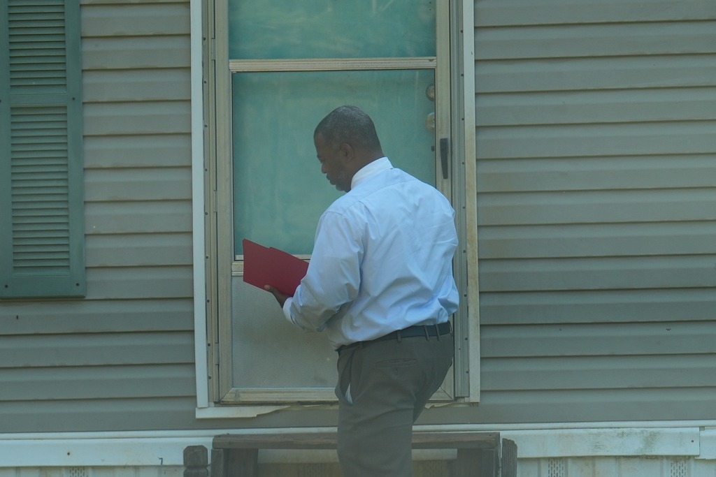 Magee High School Principal Jammal Banks is knocking on a door. 