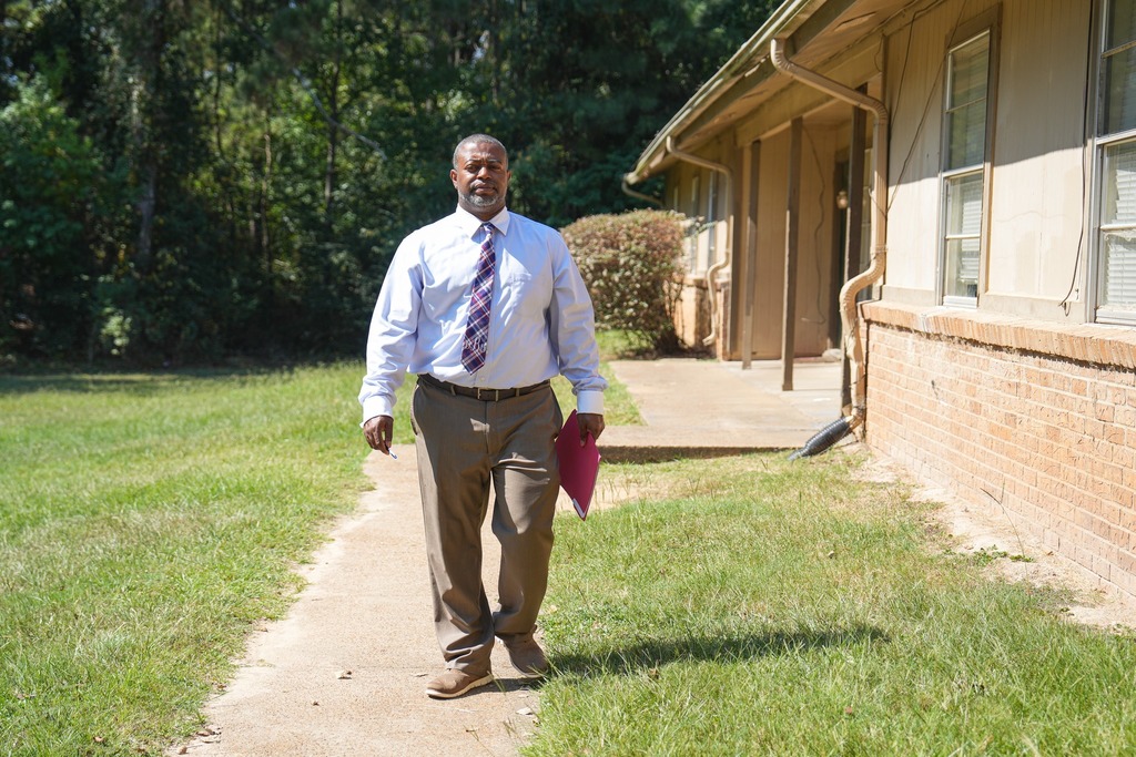 Magee High School Principal is visiting a home.