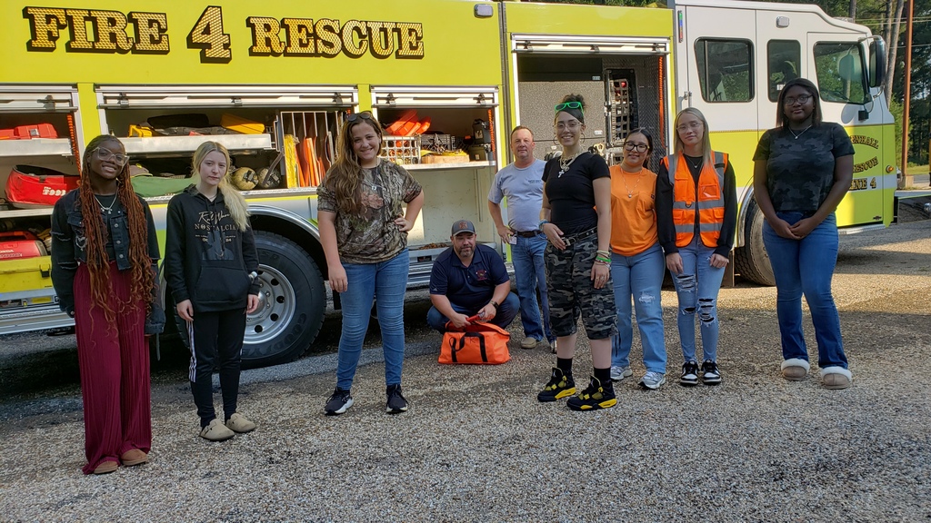 Students stand near a fire truck after hearing Mendenhall Fire Chief speak