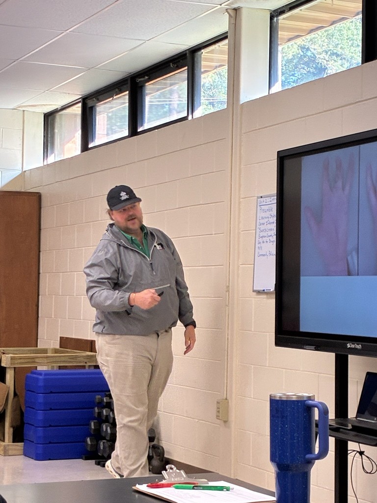A man is speaking to students.