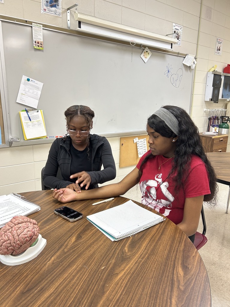 Health Sciences students practice taking pulses.