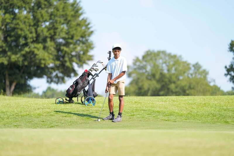 Mendenhall High School Golfer taking a swing at a golf ball.