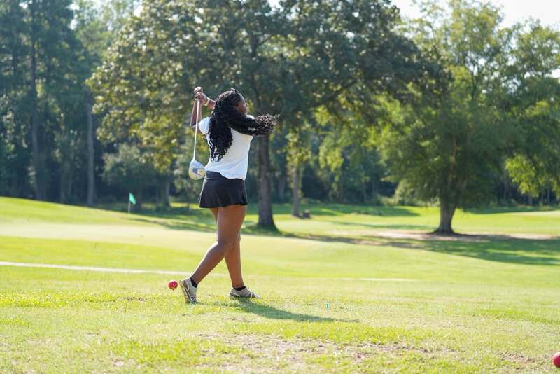 Mendenhall High School Golfer taking a swing at a golf ball.