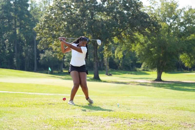 Mendenhall High School Golfer taking a swing at a golf ball.