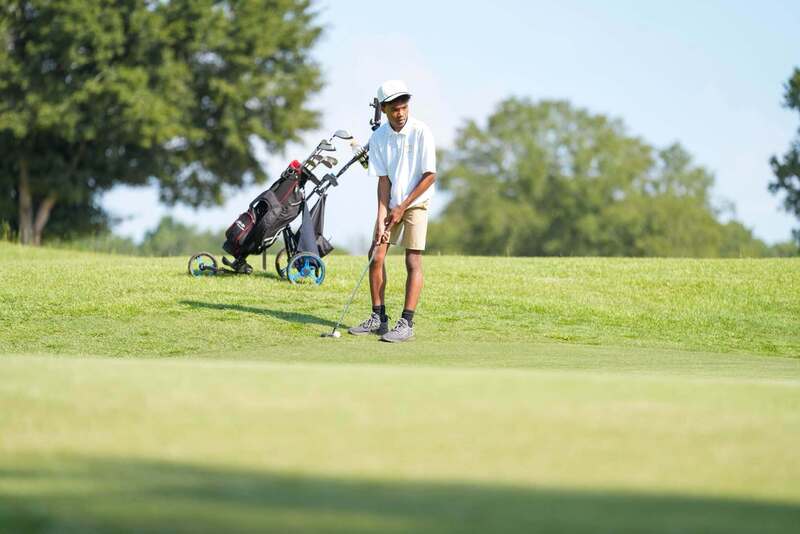 Mendenhall High School Golfer taking a swing at a golf ball.
