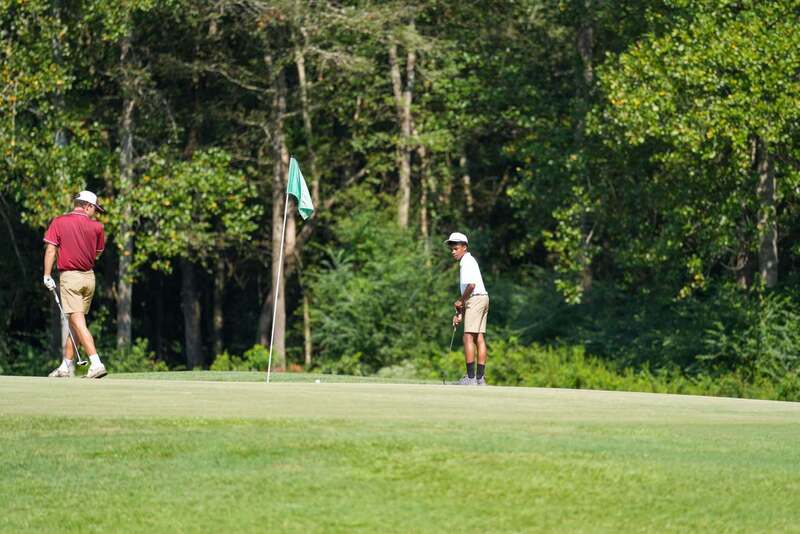 Mendenhall High School Golfer taking a swing at a golf ball.