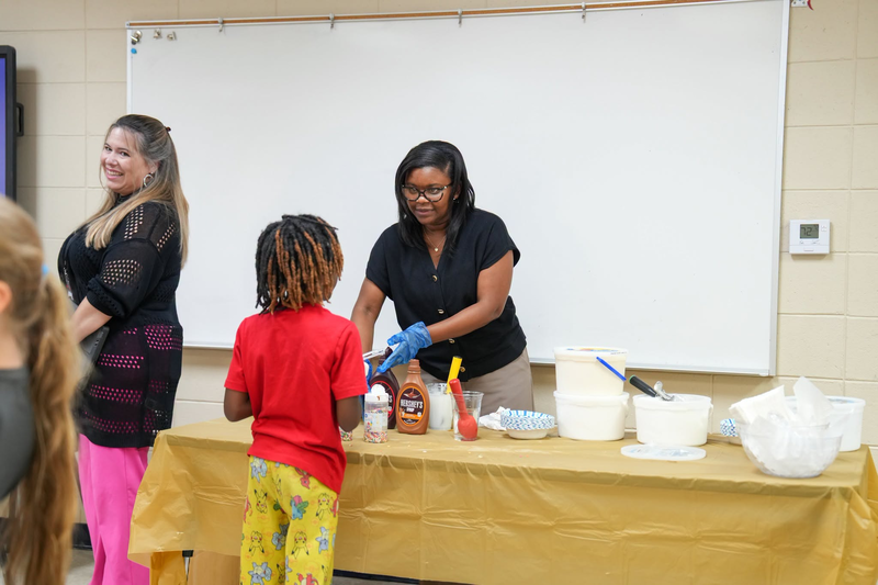 Mendenhall Elementary assistant principal serving ice cream to a student.