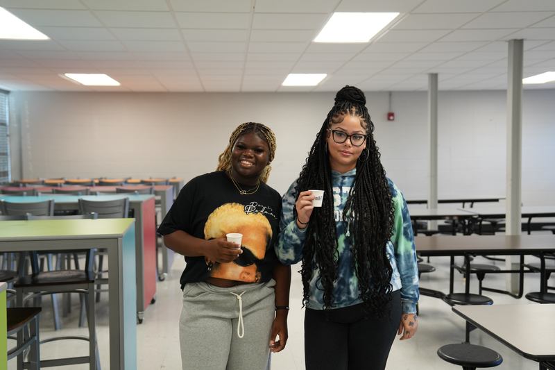 Two  high school students give a thumbs up for Moo Brew Coffee