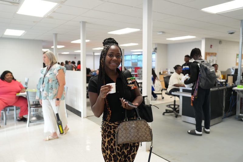 A high school girl gives a thumbs up for Moo Brew Coffee