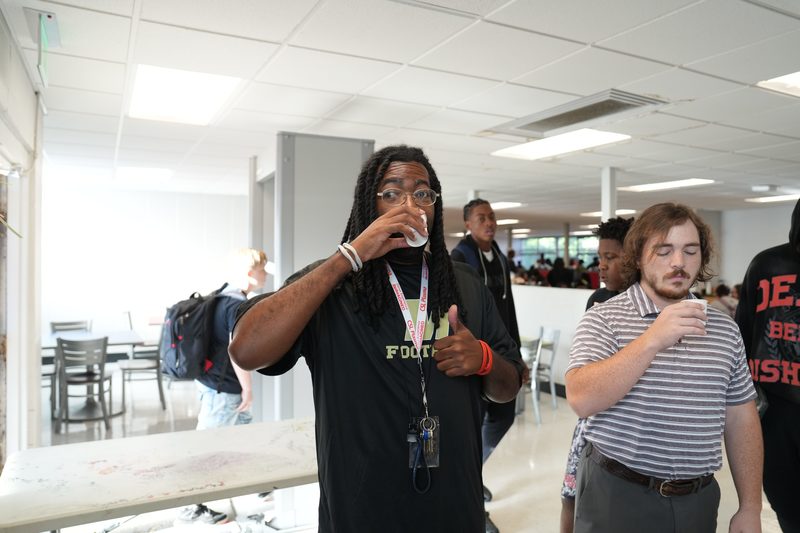 A teacher gives a thumbs up for Moo Brew Coffee