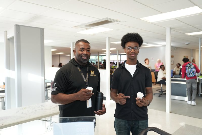 A coach and a student try Moo Brew Coffee