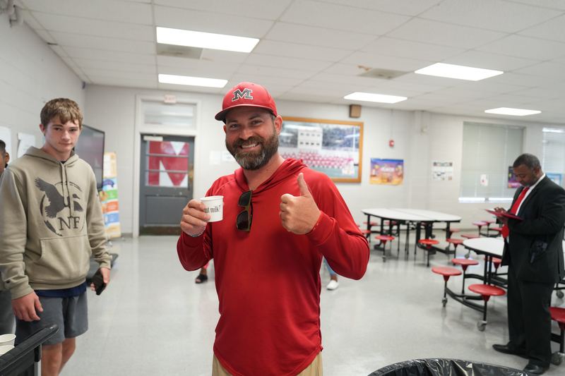 A coach is giving thumbs up for Moo Brew