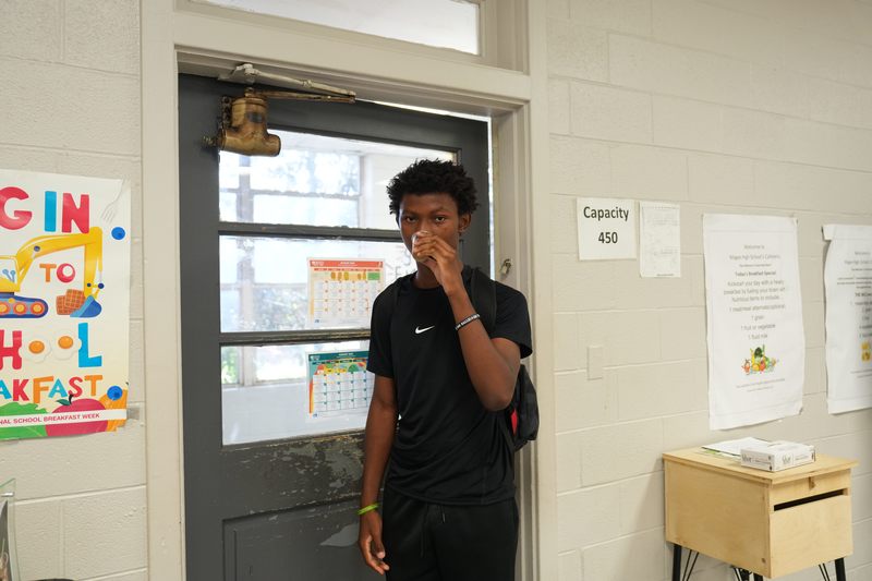 A male high school student tastes Moo Brew Coffee