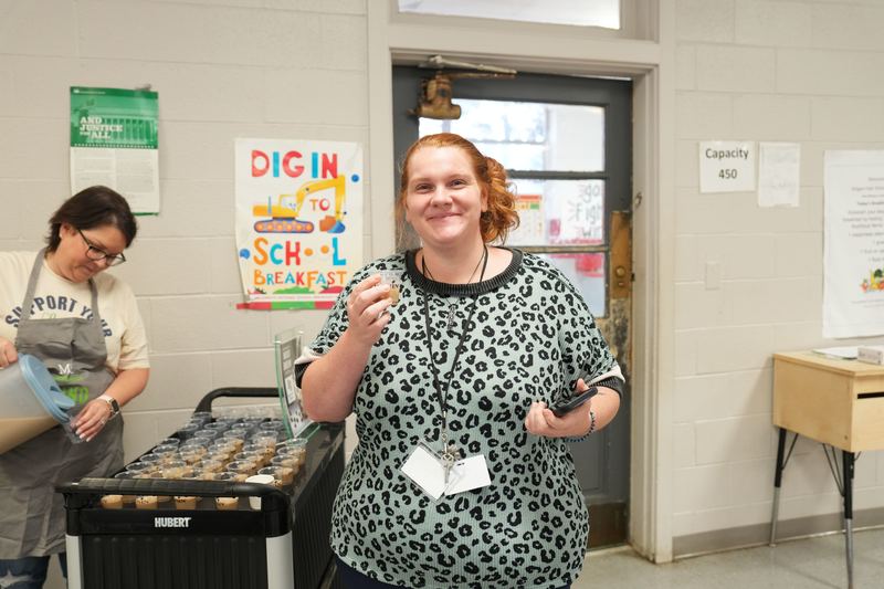 A teacher poses with Moo Brew