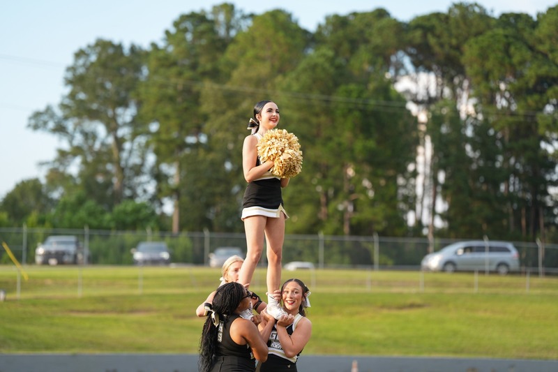Cheerleaders doing a stunt.