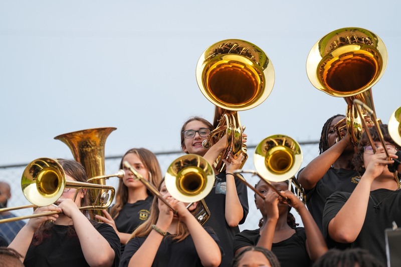 Tuba player smiles with her instrument