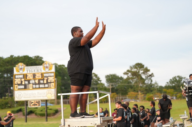 Drum major conducting the marching band