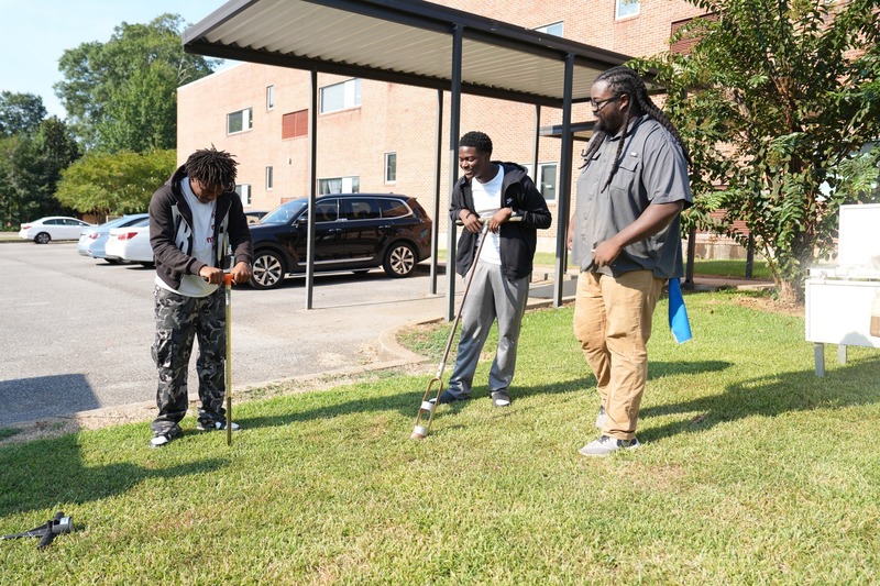 Students test out digging tools used to test soil.