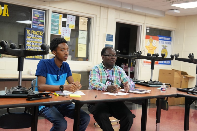 A high school student and an Agriculture teacher are participating in a discussion.
