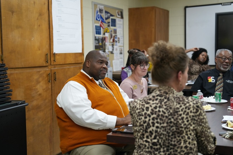 SCSD Superintendent is listening carefully to someone speak.