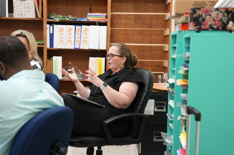 A lady is participating in a group discussion.