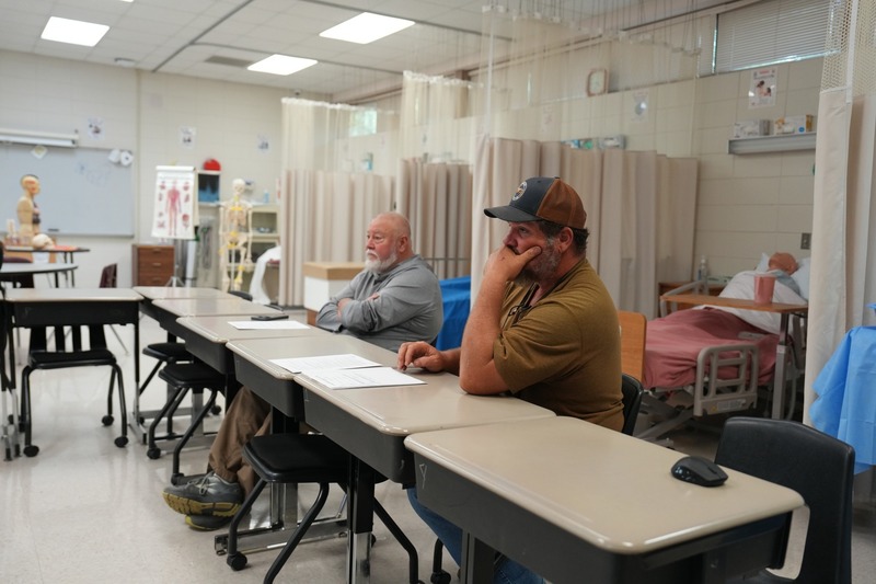 Parents are listening to a discussion on Health Sciences.