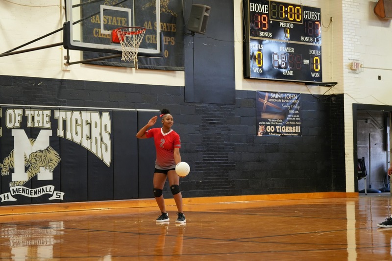 Magee volleyball player serving the ball.