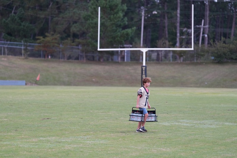Football manager carrying water