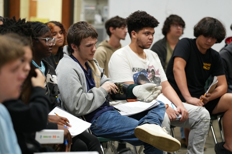 Student trying on safety gloves