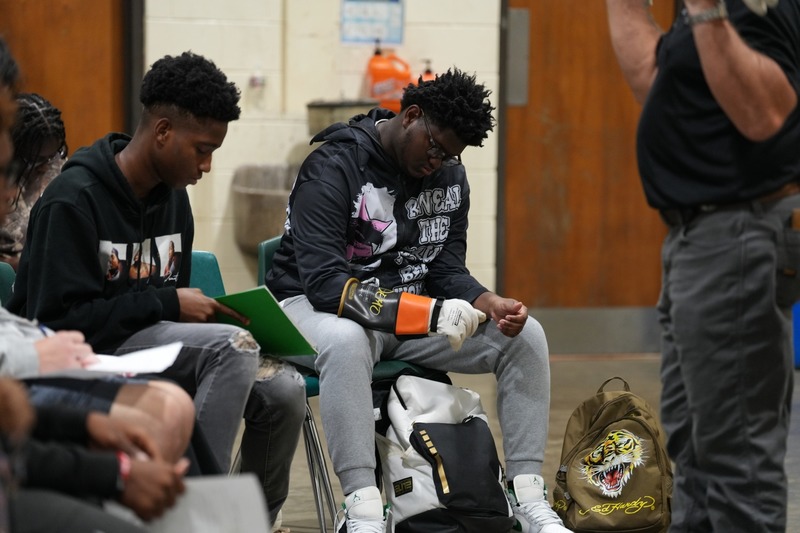 Student trying on safety gloves