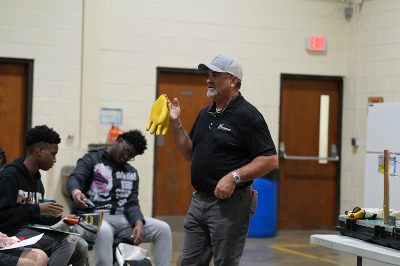 John Shoemaker showing safety gloves.