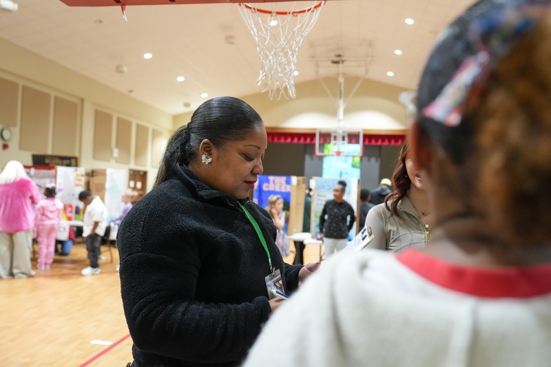 Students standing near their reading fair projects.