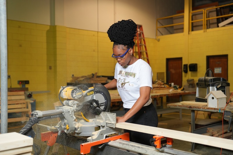 A student is using a saw