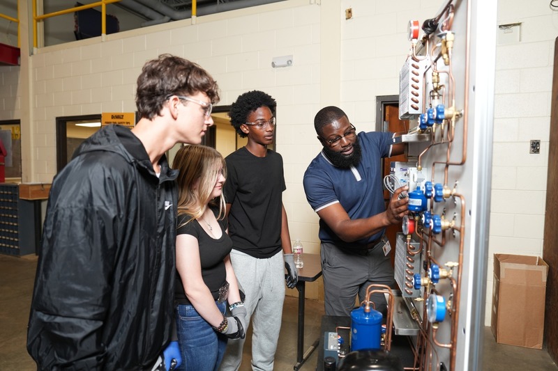 HVACR instructor explaining equipment to students
