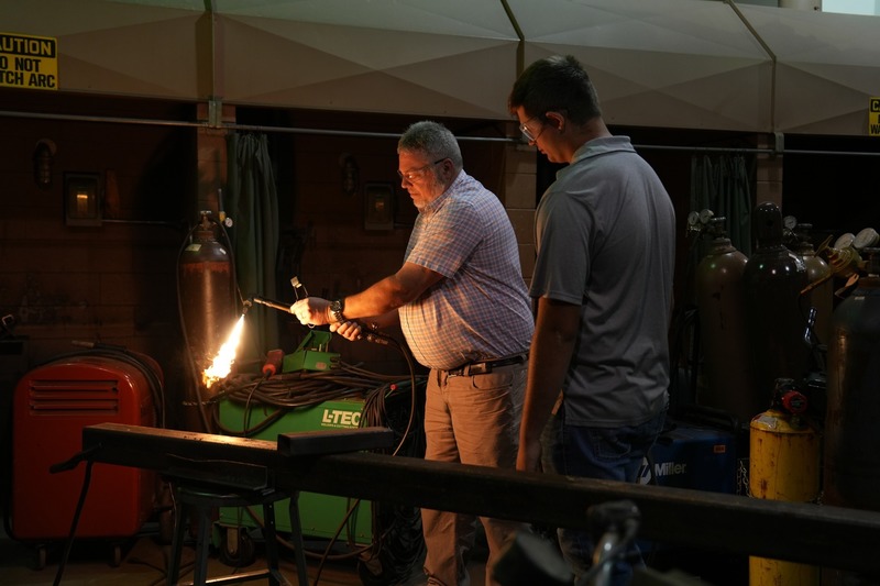 Metal Fabrication instructor demonstrating how to use a machine.