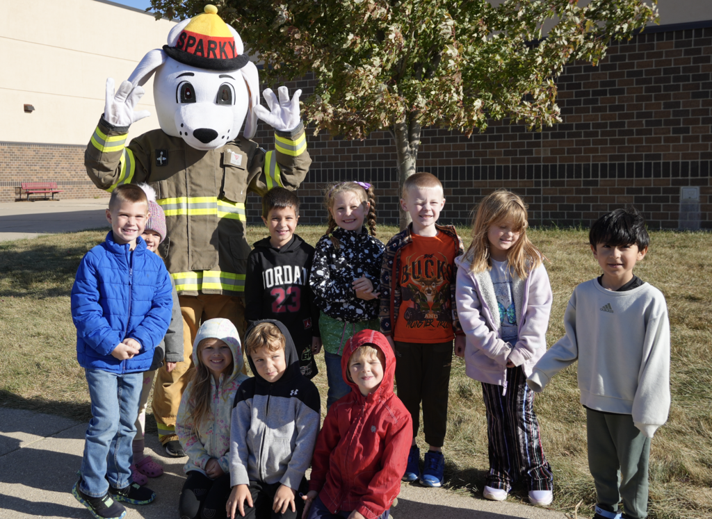 Kids outside for Fire safety week with Sparky the fire dog.