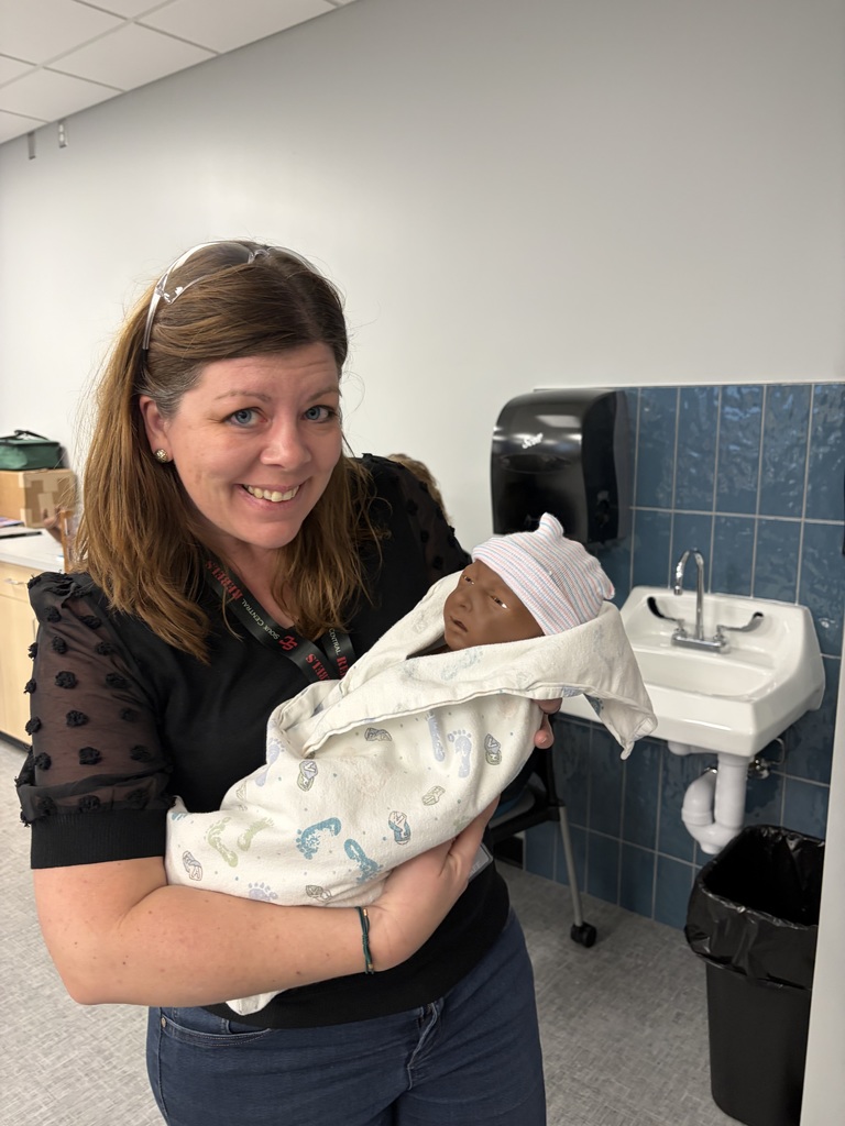 staff interacting with healthcare mannequin